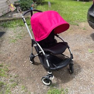 Bugaboo bee plus stroller with pink and blue canopy options.